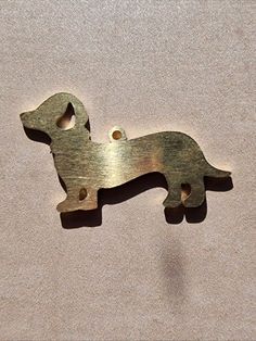 a metal object that looks like a dog on the ground with holes in it's side