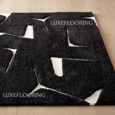 a black and white rug with the words lukeflooring on it in different languages