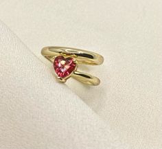 Our Heart Shaped Ruby Ring embodies a bright red ruby crystal as the main stone throughout its gold band ✔ Gold Plated 925 Sterling Silver ✔ Hypoallergenic ✔ Tarnish Free ✔ High Quality CARE: Our jewelry can handle a normal amount of contact with water and sweat, but we suggest limited contact for longer durability. We take pride in using high quality materials for those pieces that are not stainless steel or gold filled but we ask that you try to avoid contact with harsh chemicals that can mess Gold Ruby Ring For Valentine's Day, Valentine's Day Gold Ruby Ring, Gold Heart Ring With Gemstone For Valentine's Day, Gold Heart Cut Ruby Birthstone Ring, Gold Gemstone Ring For Valentine's Day, Dainty Gold Ruby Ring For Valentine's Day, Gold Ruby Ring With Gemstone For Valentine's Day, Gold Jewelry With Lab-created Ruby As A Gift, Gold Jewelry With Lab-created Ruby For Gift