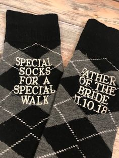 two black and white socks with the words, special socks for a special walk on them