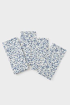 four napkins with blue and white dots on them