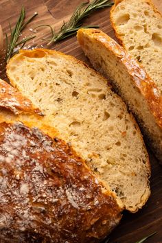 two loaves of bread sitting on top of a cutting board