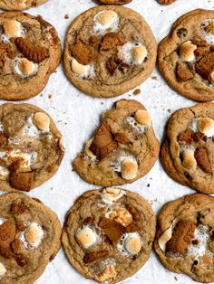 several cookies with white chocolate chips and nuts on top