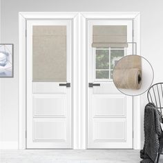 two white doors with beige blinds and a chair in front of one that has a rug on the floor