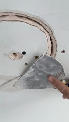 a person is painting the ceiling with white paint and silver tinkles on it