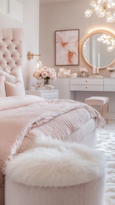 a bedroom with a bed, vanity and mirror