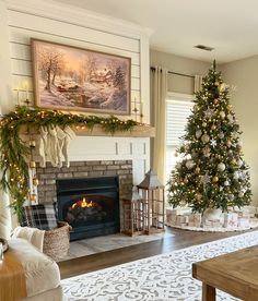 a living room with a christmas tree in the corner and other decorations on the fireplace mantel