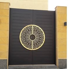 a black and gold door with a circular design on it