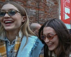 two women standing next to each other smiling