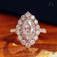 a diamond ring sitting on top of a wooden table