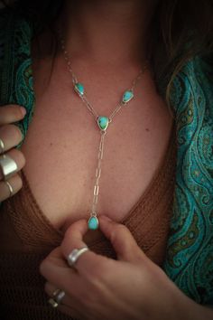 This one-of-a-kind Lariat necklace features a Y-shaped design that consists of four hand-fabricated turquoise pendant pieces. Each stone is Sonoran Mountain Turquoise, which has a beautiful complexion with variations of blues and greens. An elegant paperclip chain links all the pendants together. The piece is finished with a high polish to make it shine! MATERIALS Sonoran Mountain Turquoise Sterling Silver DIMENSIONSNecklace measures 20" with a 3.5" drop. Note: the paperclip chain allows you to wear the necklace at any length 20" or less! Simply clip at any length you'd like! Blues And Greens, Chain Links, Gift Card Shop, Lariat Necklace, Turquoise Pendant, Summer Essentials, Turquoise Sterling Silver, Earring Necklace, Ring Necklace