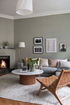 a living room filled with furniture and a fire place