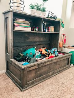 an old wooden toy chest with toys in it