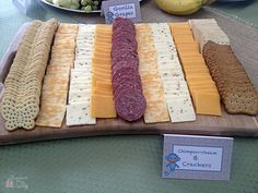 several different types of cheeses and crackers on a cutting board