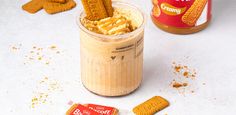 a jar filled with peanut butter and crackers next to a can of candy canes