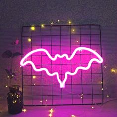 a neon sign with a bat on it in the shape of a caged wire