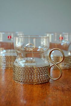 four glasses sitting on top of a wooden table