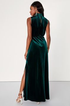 Feel like the Queen that you are in the Lulus Classic Elegance Emerald Velvet Sleeveless Mock Neck Maxi Dress! Plush velvet shapes this gorgeous dress that has a mock neckline and a sleeveless bodice with gathered fabric detailing. An elasticized waist tops a stunning maxi skirt complete with twin side slits. Cute keyhole cutout secures with a double button closure at back. Hidden back zipper/clasp. Fit: This garment fits true to size. Length: Floor length. Size medium measures 60.5" from should Green Wedding Guest Dresses, Mock Neck Maxi Dress, Fabric Detailing, Emerald Dress, Emerald Velvet, Gathered Fabric, Velvet Dress Casual, Sleeveless Mock Neck, Dress Drape