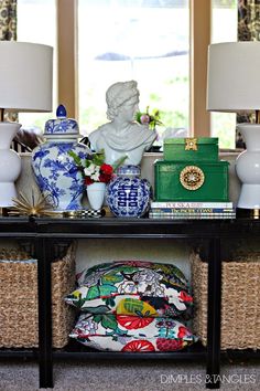 a table topped with lamps and vases filled with flowers