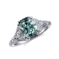 a fancy green diamond ring with filigree accents