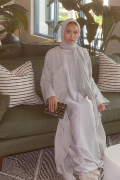 Introducing our first ever Linen Abaya, perfect for that bit of extra comfort! Delicately adorned with leaves outlined in beadwork, with folded cuffs for an elegant finish. The texture and flow of the fabric provide the highest level of comfort, with an oversized, relaxed and modest fit. Includes plain slip and matching hijab (clothing shown in images were styled for shoot purposes only). The model is 5.9 and wears a size 60. Linen Abaya, Embroidered Abaya, Slip Wedding Dress, Modest Wardrobe, Leaf Outline, Dusty Sage, Modest Fits, Hijabi Aesthetic, Hijabi Outfits Casual