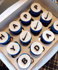 cupcakes with blue and white frosting are arranged in the shape of letters