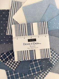 blue and white fabrics with the label denim & dots on them, all stacked together