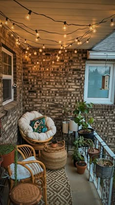 an outdoor patio with lights strung from the ceiling and wicker furniture on the porch