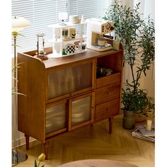 a living room with furniture and plants on the table in front of window covered by blinds