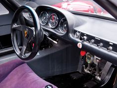 the interior of a race car with purple seats and steering wheel, including dashboards