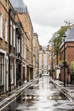 an empty city street is shown in the rain