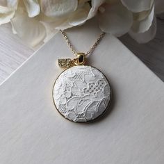 This vintage lace necklace is the perfect gift for those that love a timeless and elegant style. The white floral lace from the 1950s evokes a sense of delicate beauty, with a background of shiny cream color satin that highlights the intricate lace design. It's set in a gold metallic metal alloy pendant, with a dainty gold stainless steel chain that measures 22 inches in total length. Letter charm: The finishing touch is the capital letter initial charm that adorns the top of the pendant. This charm offers the perfect way to make this necklace a thoughtful and personalized gift. Gift box: The necklace will be packaged in a stylish, branded gift box, ready to be presented with love and care.  Gift notes:  Write a personalized note to your loved one at checkout, and it will be printed on dec 13th Anniversary, Anniversary Gift For Wife, Lace Necklace, Delicate Beauty, Letter Charm, Anniversary Gifts For Wife, Branded Gifts, Personalized Gifts For Her, Letter Charms