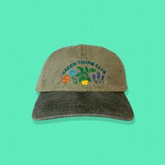 Perfect for the garden enthusiast and green thumb! This dad hat has a pre-worn feel and look and is perfect for your trips to the greenhouse or when tending to the garden. Embroidered directly onto a super comfy dad hat, that's sure to become your new favorite. Hat specs: 100% cotton pigment dyed twill Unstructured, six-panel, low profile Self-fabric sweatband and six sewn eyelets Self-fabric strap with brass snap buckle and sewn grommet Vintage Green Dad Hat With Curved Bill, Green Curved Brim Dad Hat For Outdoor, Green Embroidered Baseball Cap For Outdoor, Vintage Green Dad Hat With Curved Brim, Green Dad Hat For Spring, Green Vintage Dad Hat For Outdoor, Spring Green Trucker Hat With Curved Bill, Spring Outdoor Dad Hat With Curved Brim, Green Curved Brim Dad Hat For Spring