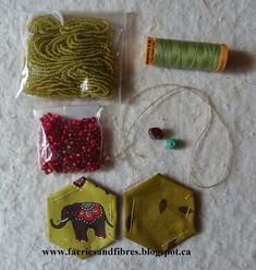 sewing supplies and thread laid out on the floor for making bead decorations, including an elephant ornament