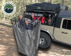 an older man is in the back of a pick up truck with a cover over it