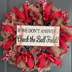 a baseball wreath that says, if we don't answer check the ball field