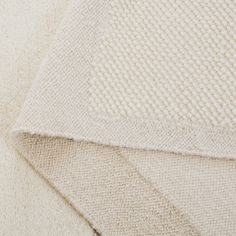 the textured fabric is white and beige, which has been folded in half to make it