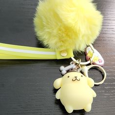 a keychain with a stuffed animal attached to it's side on a table