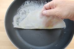 a person is frying some food in a pan