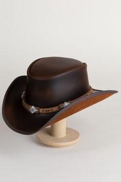 Laramie Leather Cowboy Hat with Conchos | Overland Brown Top Hat With Curved Brim For Western-themed Events, Brown Curved Brim Top Hat For Western-themed Events, Western High Crown Top Hat For Ranch, Vintage Leather Fedora For Rodeo, Leather Hats For Country Events In Distressed Brown, Distressed Brown Leather Hats For Country Events, Leather Distressed Brown Hats For Country Events, Country Style Distressed Brown Leather Hat Bands, Rugged Brimmed Fedora For Western-themed Events