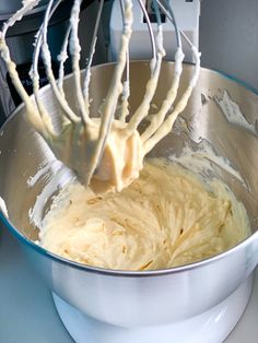 a mixing bowl filled with batter and an electric mixer