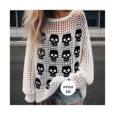 a woman wearing a white sweater with black skulls on it and the words style 122