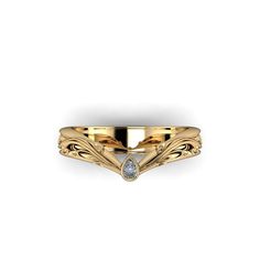 a yellow gold ring with a diamond in the center and an intricate design on it