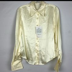 100% Silk Cream Button Down Blouse Size 6p. This Is A Beautiful Blouse With French Cuffs And Silk Covered Buttons. It's A Very Classy Piece. As The Tag Stats It Has A Powdery Soft Feel And The Crease Is A Part Of The Design And Not Flaws. Its Brand New With Tags And Has An Extra Button For Repairs. Approximate Measurements Pit To Pit 19" Length 24" Nwt Elegant Fitted Blouse With Snap Buttons, Classic Spring Blouse With Buttons, Formal Button-up Blouse With Snap Buttons, Formal Snap Button Button-up Blouse, Formal Snap Button-up Blouse, Classic Spring Blouse With Button Closure, Fitted Silk Button-up Shirt, Fitted Cream Tops With Button Cuffs, Casual Silk Blouse With Buttons