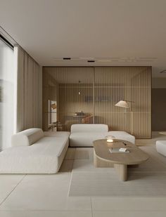 a living room filled with white furniture next to a window