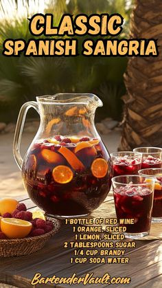 a pitcher of red sangria with orange slices and strawberries in front of it