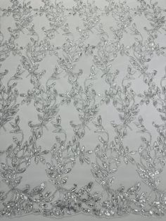 silver sequins and leaves on white organ - lace fabric, sold by the yard