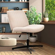 an office chair sitting on top of a hard wood floor next to a book shelf