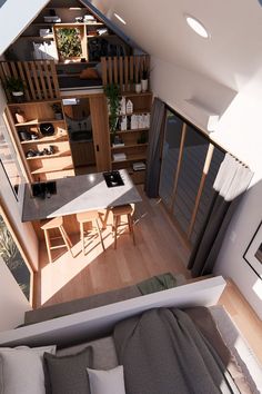 an aerial view of a living room and dining area in a tiny house with wood flooring