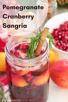 pomegranate cranberry sangria in a mason jar with cinnamon stick